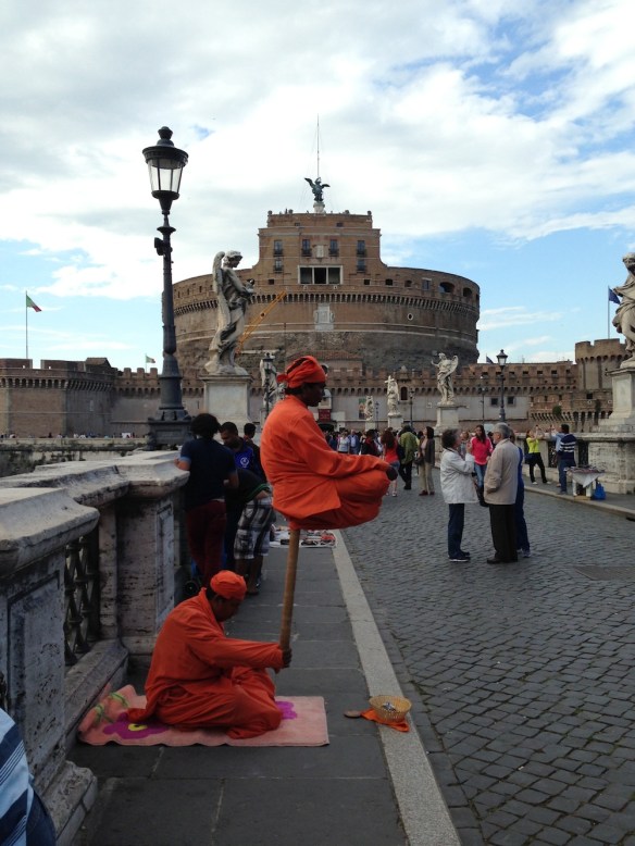 monks or Buddhists play meditation infront of the st.angelo with their orange outfit and turbans  