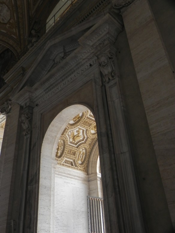 a picture of the door that takes you to the names of the pops at the vatican in gold 