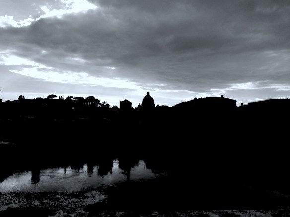 a beautiful sun dusk photo of vaticano from castel st angelo over the bridge and river 