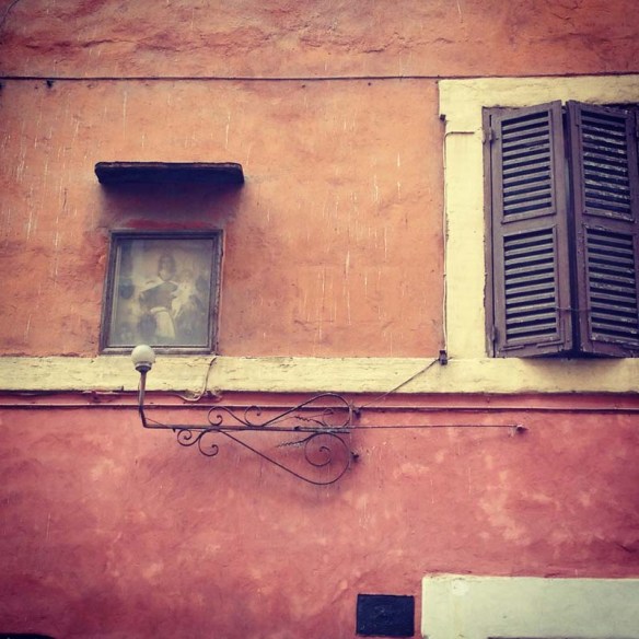 Red and orange street wall with small cute windows