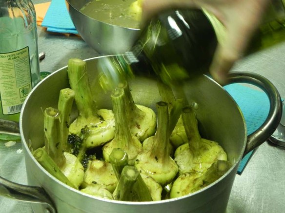 Adding oil to potatoes before baking with Chef andrea 