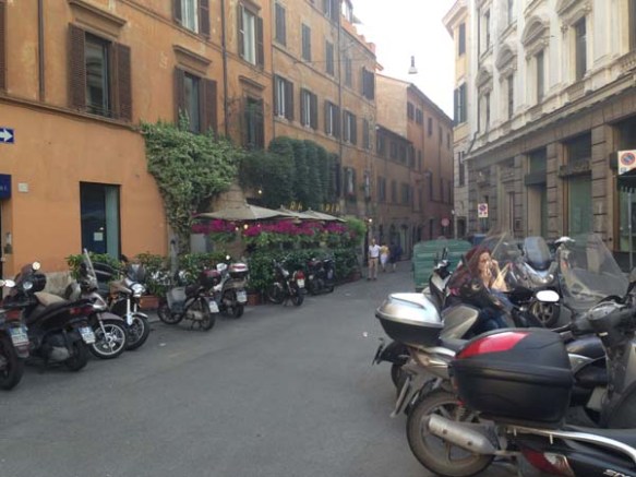 motorbikes scattered in the middle of the street of campo de'fiori