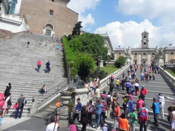people and tourists climbing the Capitoline Hill in rome italy 