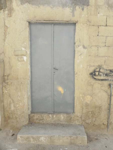 Grey door in the middle of a very old house Downtown Amman Al Balad