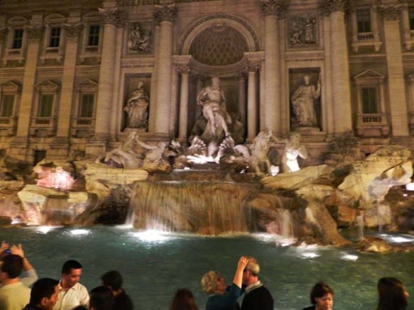 two old couple loving one another infront of the Trevi Fountain