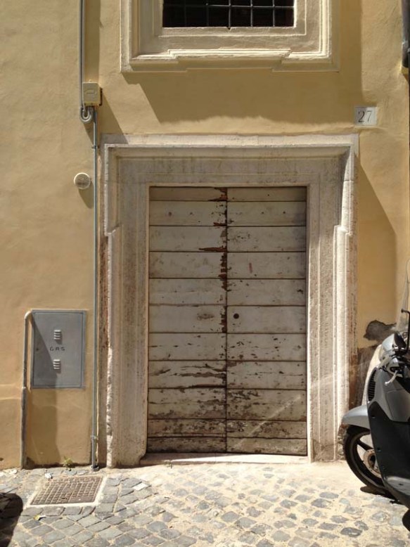 a very old vintage beige door with a motor bike 