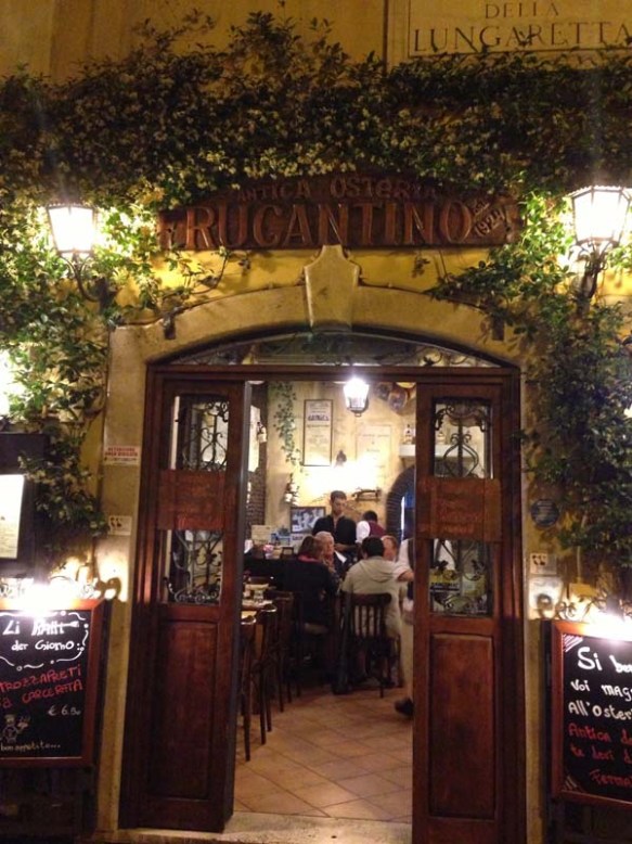 Restaurant entrance with green trees surrounding it 