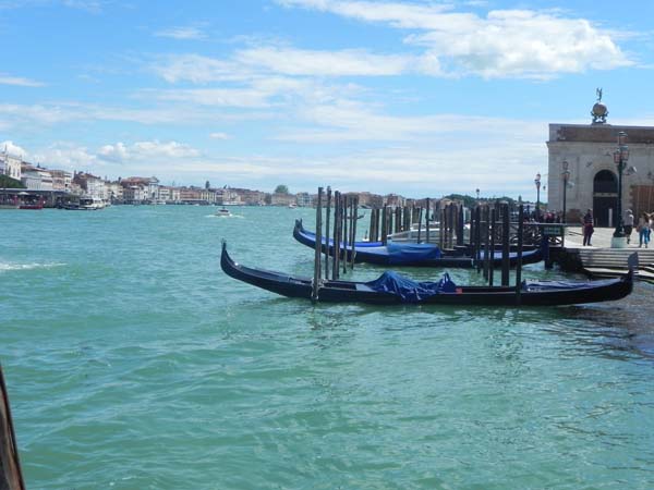 A gondola and a gondolier at the Grand Canal blue skies blue river