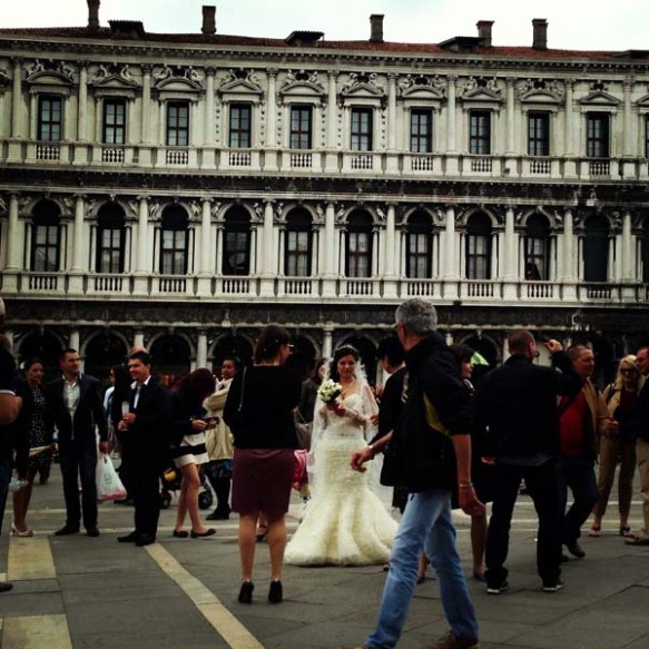 A bride in between all the people and tourists in piazza saint marco