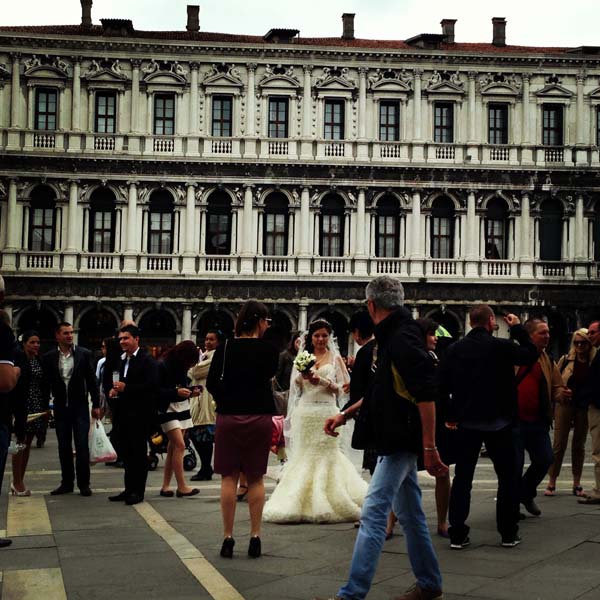 A bride in between all the people and tourists in piazza saint marco