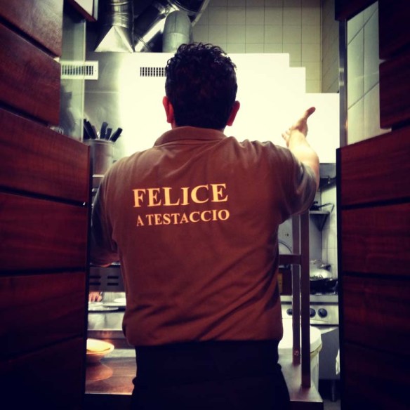 A waiter wearing a Felice uniform while serving food 