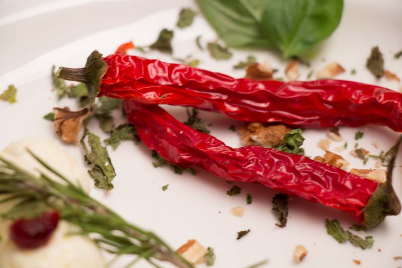 A picture of 2 chillies and some rosemary