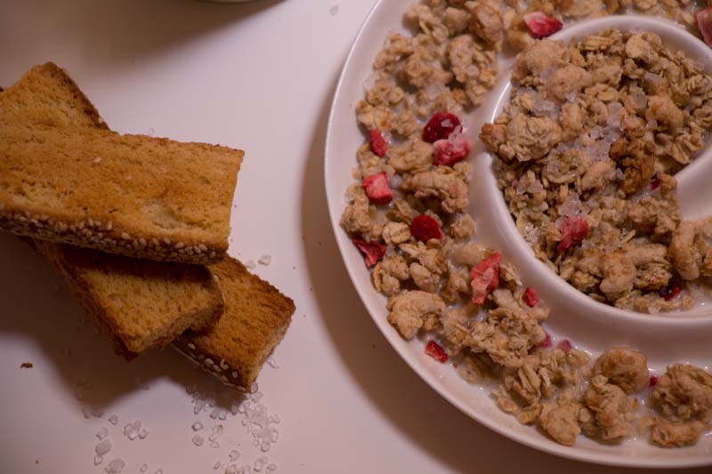 crunchy oats and raspberry with milk and biscuits