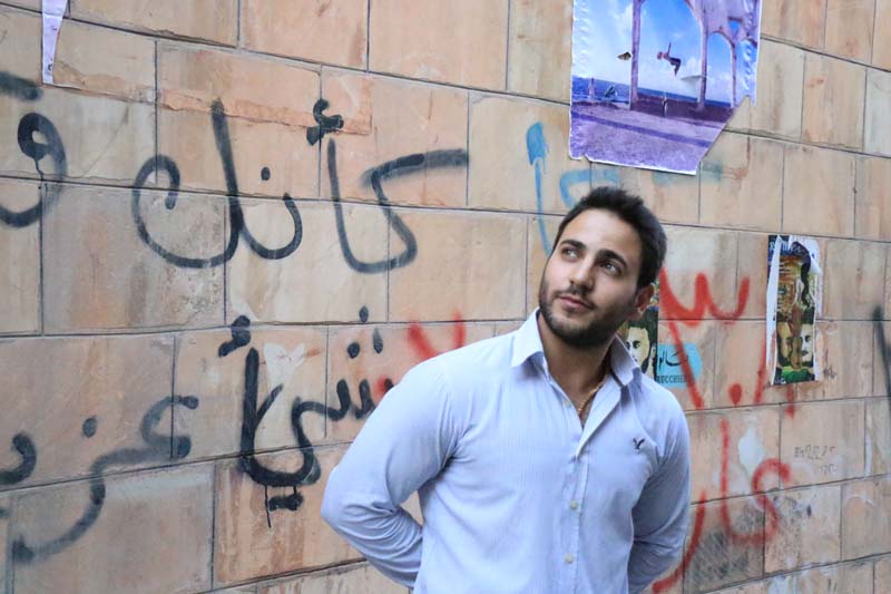 A male model infront of brick at old town downtown Amman