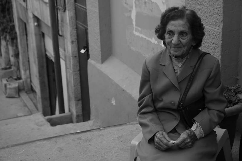 Old jordnain woman sitting waiting for photographers to take her photo