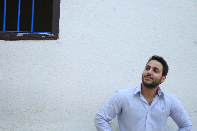 Model next to window with blue jail window style