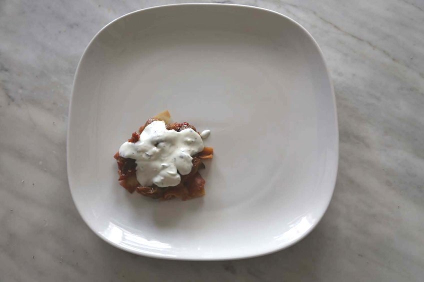 Middle-Eastern Eggplant Casseroles also known as Fatet Batinjan فتت بيتنجان or Fatet Makdous فتيت مكدوس empty white plate add fried bread