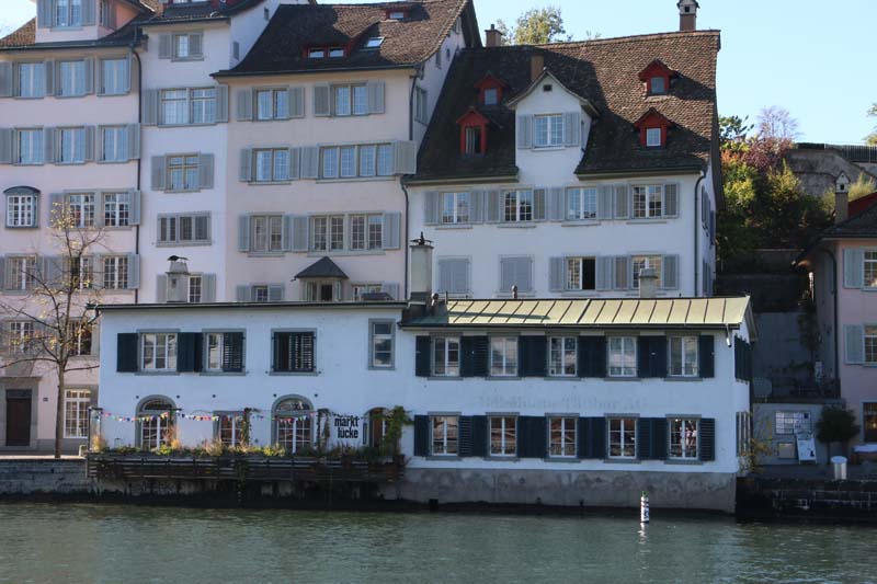 A photo of guild houses in Zurich brown blue and pink architecture from the 1336
