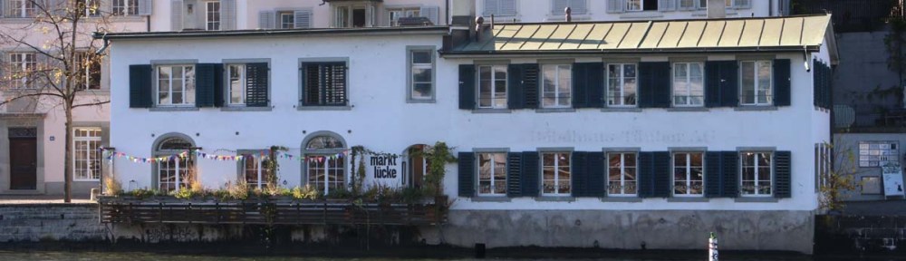 A photo of guild houses in Zurich brown blue and pink architecture from the 1336