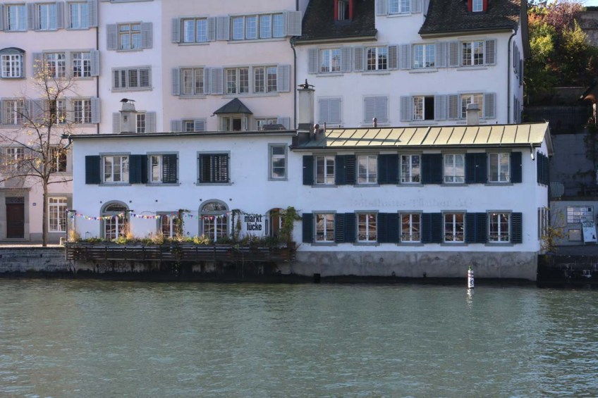 A photo of guild houses in Zurich brown blue and pink architecture from the 1336