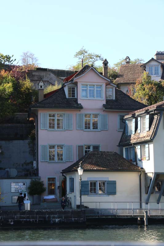 A photo of guild houses in Zurich brown blue and pink architecture from the 1336