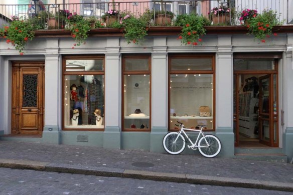 White bicycle infront of a shop in ZUrich Switzerland 