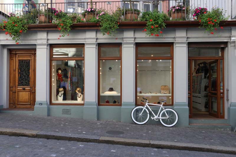 White bicycle infront of a shop in ZUrich Switzerland
