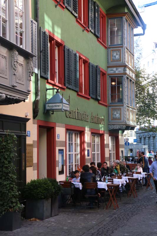 A photograph of green and red old building in Zurich Altstadt old town first district