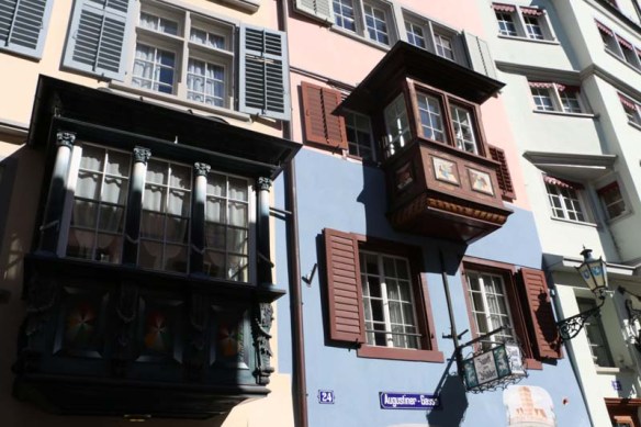 A photo of guild houses in Zurich brown blue and pink architecture from the 1336