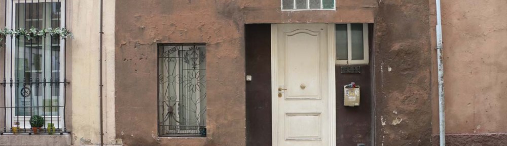 Brown old door and house in Barcelona