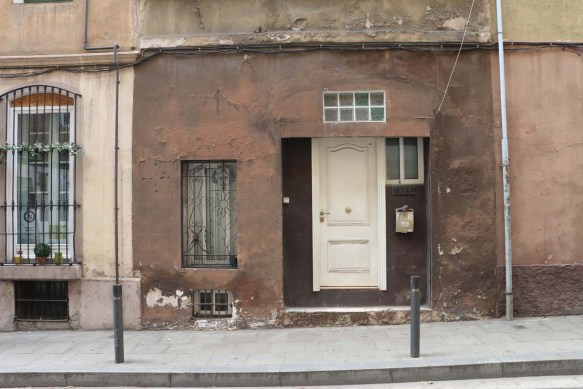 Brown old door and house in Barcelona
