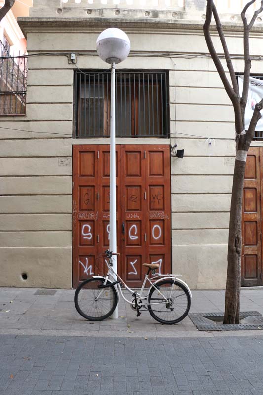 Brown door with bicycle in Barcelona