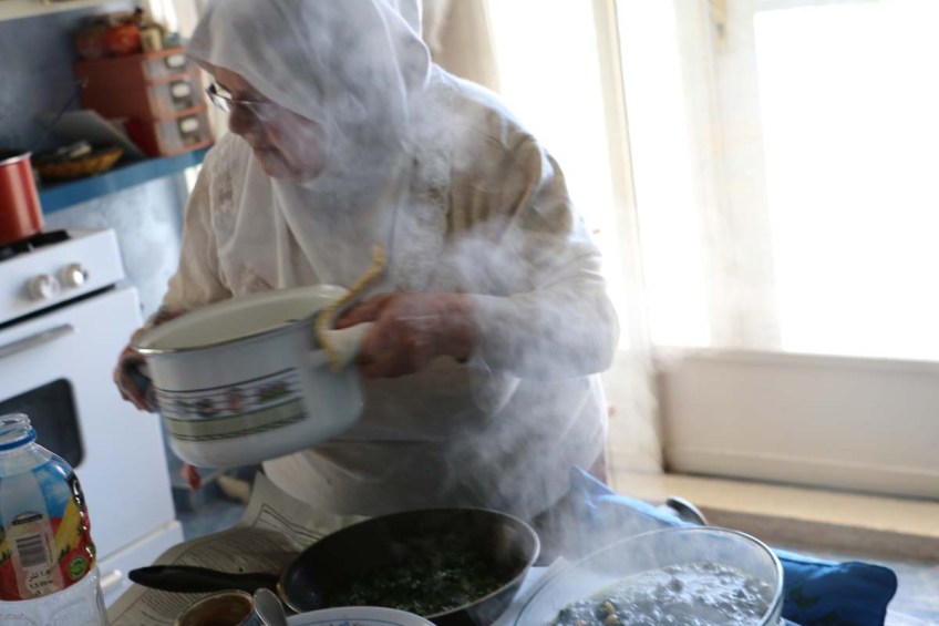A woman from Nablus making food for guests