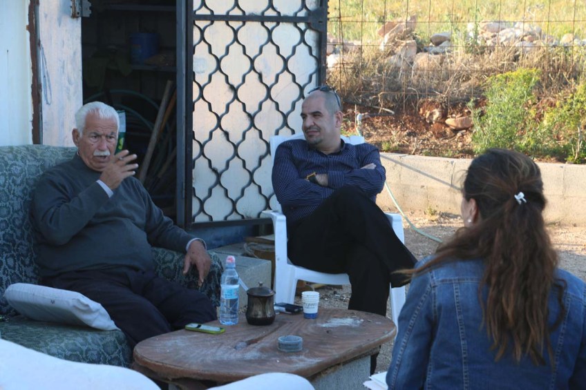 An old man picking oranges in a village next to Nazareth