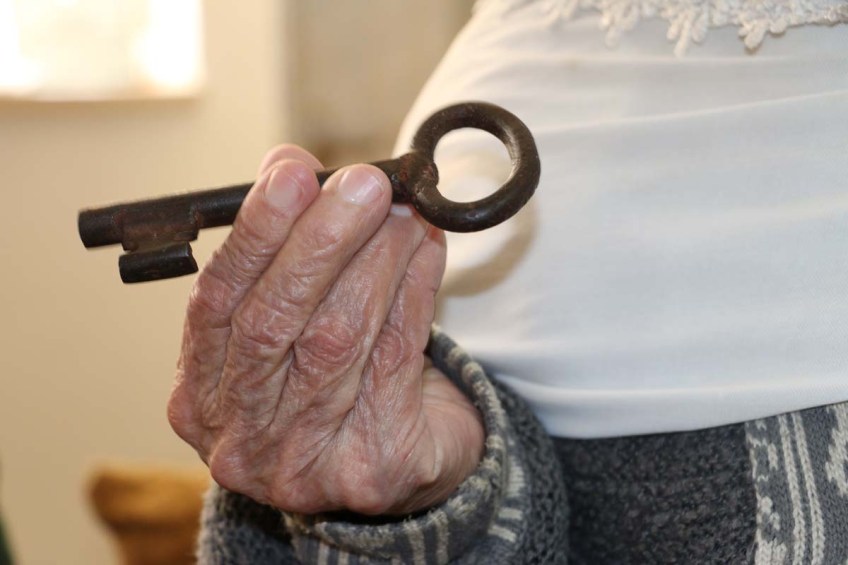 An old Palestinian woman from Saraa holding her occupied homes key by the Israelis