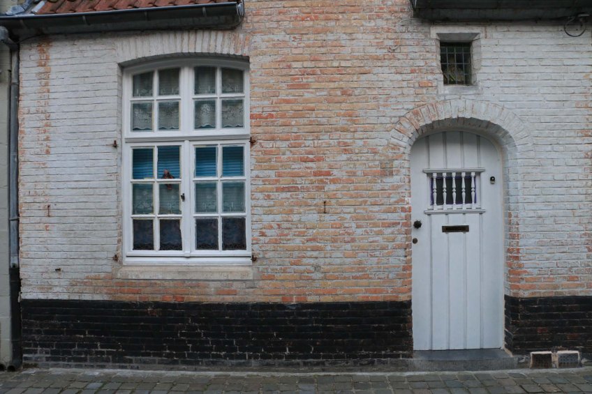 white door, pink bricks